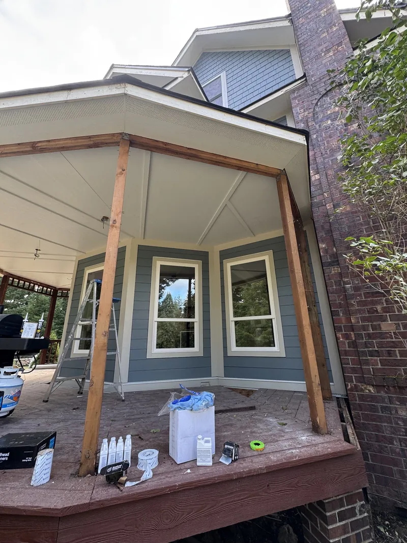 Covered patio with a painted ceiling, new posts and new windows