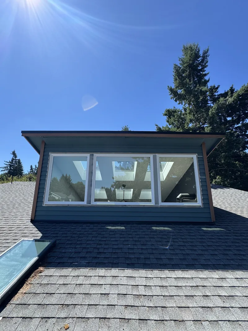 Composition-shingle roof with a window dormer and a skylight