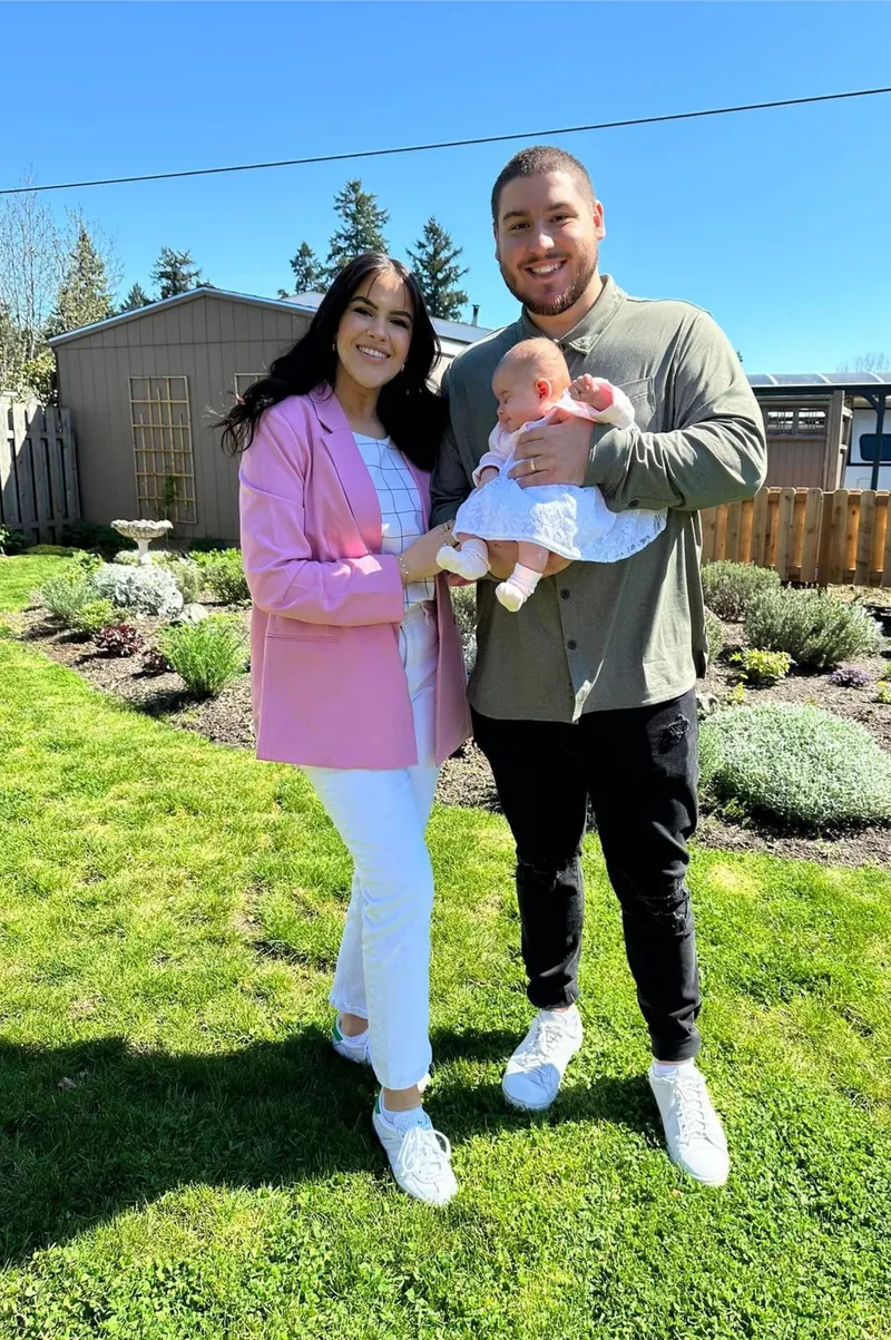 One of the IE Pro Exteriors owners with his wife and baby in a backyard garden